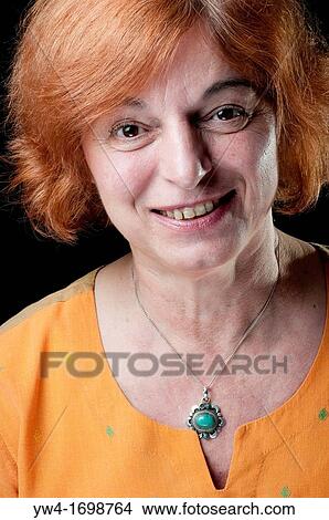 Middle aged woman with red hair looking happy View Large Photo Image Picture - Middle aged woman with red hair looking happy. Fotosearch
