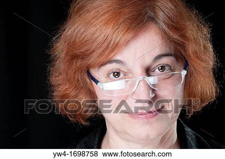 Middle aged woman with red hair smiling View Large Photo Image Stock Photo - Middle aged woman with red hair smiling. Fotosearch
