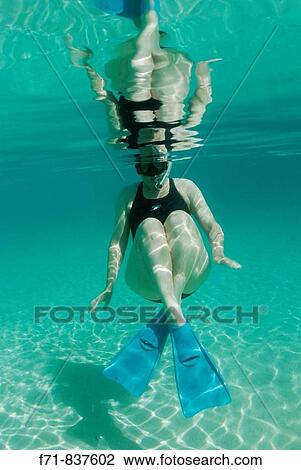 Middle aged women in one piece swim suit snorkelling over sandy on tropical beach. Ha`apai Group, Tonga. South Pacific Ocean. View Large Photo Image Stock Image - Middle aged women in one piece swim suit snorkelling over sandy on tropical beach. Ha`apai Group, Tonga. South Pacific Ocean.. Fotosearch