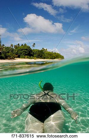 Middle aged women in one piece swim suit snorkelling over sandy on tropical beach. Ha`apai Group, Tonga. South Pacific Ocean. View Large Photo Image Stock Photography - Middle aged women in one piece swim suit snorkelling over sandy on tropical beach. Ha`apai Group, Tonga. South Pacific Ocean.. Fotosearch