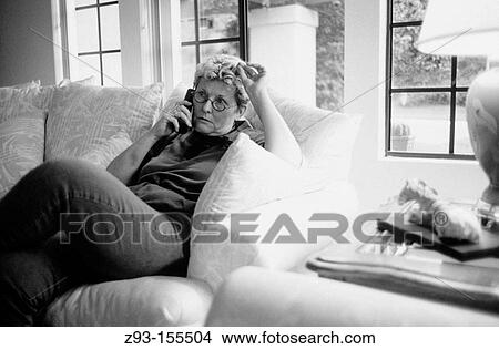 Picture - Middle-aged women on phone at home. Fotosearch