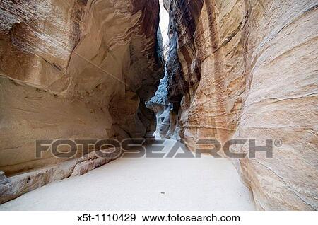 Middle East, Jordan, Petra, UNESCO World Heritage Site Al-Siq The main entrance into the city A 1207 metres long 3 to 16 metres wide and 100 Meters high natural gorge April 2008 View Large Photo Image Stock Photo - Middle East, Jordan, Petra, UNESCO World Heritage Site Al-Siq The main entrance into the city A 1207 metres long 3 to 16 metres wide and 100 Meters high natural gorge April 2008. Fotosearch