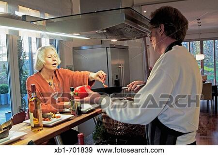 Middleaged couple is cooking View Large Photo Image Stock Photo - Middleaged couple is cooking. Fotosearch