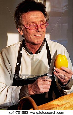 Stock Image - Middleaged man is cooking. Fotosearch