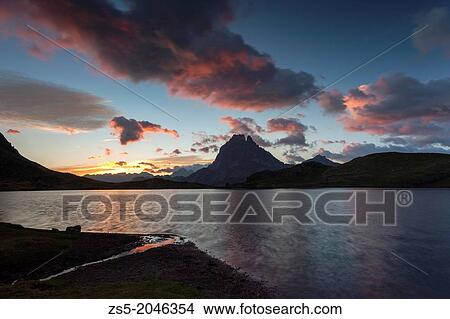 Midi d? Ossau at sunrise with clouds in Ayous lake, Pyr? n? es-Atlantiques, France, Europe. View Large Photo Image Picture - Midi d? Ossau at sunrise with clouds in Ayous lake, Pyr? n? es-Atlantiques, France, Europe.. Fotosearch