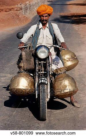 Stock Photo - MILK COLLECTOR, BUNDI ROAD, RAJASTHAN, INDIA. Fotosearch