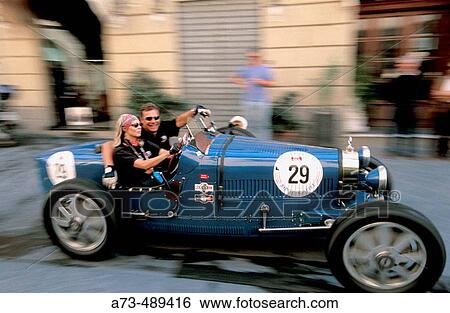 Stock Photograph - ? Mille Miglia? historical car race along Italy at Via Mazzini. Arezzo. Tuscany. Italy.. Fotosearch