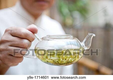 Minglou Chen, owner of the Minglou Tea House displays one of his freshly made teas during a traditional tea ceremony View Large Photo Image Stock Image - Minglou Chen, owner of the Minglou Tea House displays one of his freshly made teas during a traditional tea ceremony. Fotosearch