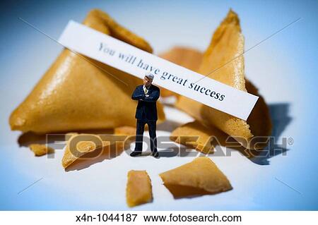 Miniature businessman in front of fortune cookies with message reading you will have great success View Large Photo Image Stock Photo - Miniature businessman in front of fortune cookies with message reading you will have great success. Fotosearch