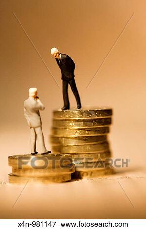 Miniature businessmen standing on coins on financial newspaper This photo illustrates the vast gap in wages within companies Senior executives earnings have increased 17 times faster than the average worker in recent years View Large Photo Image Stock Photo - Miniature businessmen standing on coins on financial newspaper This photo illustrates the vast gap in wages within companies Senior executives earnings have increased 17 times faster than the average worker in recent years. Fotosearch