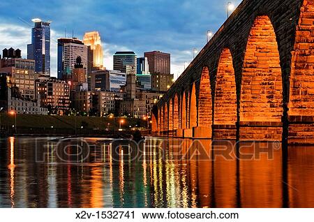 Minneapolis skyline and stone arch bridge at dusk with Mississippi River in foreground View Large Photo Image Stock Image - Minneapolis skyline and stone arch bridge at dusk with Mississippi River in foreground. Fotosearch