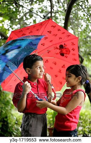 Mischievous kids in the rain slight motion blur trying to get the most colorful umbrella View Large Photo Image Stock Image - Mischievous kids in the rain slight motion blur trying to get the most colorful umbrella. Fotosearch