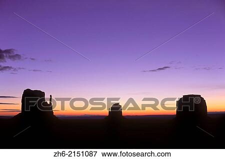 Mitten Buttes silhouetted against dawn sky, Monument Valley Navajo Tribal Park, Arizona USA. View Large Photo Image Stock Photo - Mitten Buttes silhouetted against dawn sky, Monument Valley Navajo Tribal Park, Arizona USA.. Fotosearch