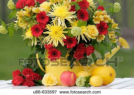 Stock Photo - Mixed flowers watering can. Fotosearch