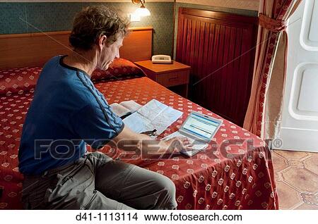 mobile device netbook man bedside map View Large Photo Image Picture - mobile device netbook man bedside map. Fotosearch