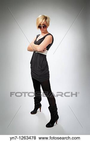 Stock Photo - Model in boots and sunnies. Fotosearch