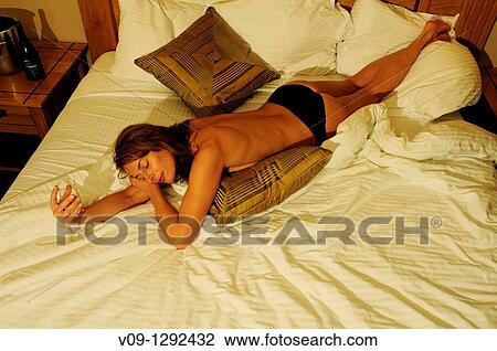 Model wearing black panties lying on bed with champagne View Large Photo Image Stock Image - Model wearing black panties lying on bed with champagne. Fotosearch