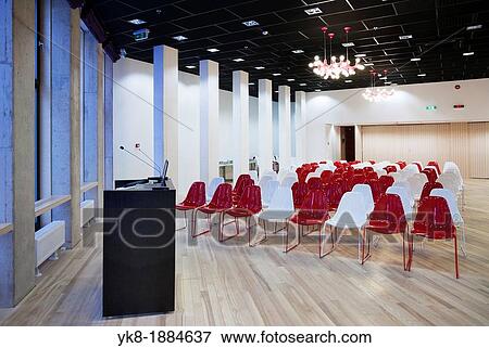 Stock Photo - Modern large conference hall with lectern podium and colourful chairs in auditorium of Tartu Health Care College in Estonia. Fotosearch