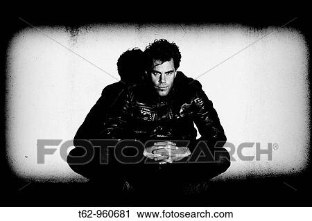Modern young man sitting on the floor Lights and shadows Black and white View Large Photo Image Stock Image - Modern young man sitting on the floor Lights and shadows Black and white. Fotosearch