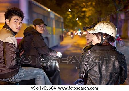 Modern youth on scooters on the streets of Vietnam at night View Large Photo Image Picture - Modern youth on scooters on the streets of Vietnam at night. Fotosearch