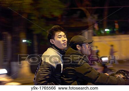 Modern youth on scooters on the streets of Vietnam at night View Large Photo Image Stock Photograph - Modern youth on scooters on the streets of Vietnam at night. Fotosearch