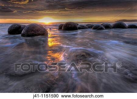 Moeraki boulders at dawn as SW front passes overhead, near Oamaru, Otago, View Large Photo Image Stock Image - Moeraki boulders at dawn as SW front passes overhead, near Oamaru, Otago,. Fotosearch