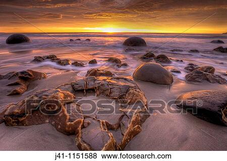 Moeraki boulders at dawn as SW front passes overhead, near Oamaru, Otago, View Large Photo Image Stock Photo - Moeraki boulders at dawn as SW front passes overhead, near Oamaru, Otago,. Fotosearch