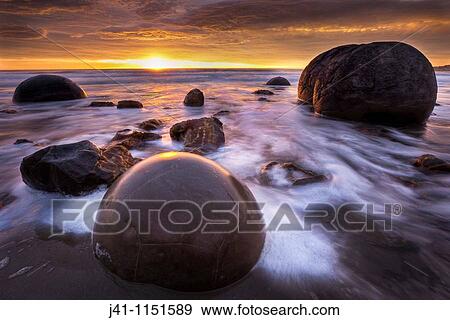 Moeraki boulders at dawn as SW front passes overhead, near Oamaru, Otago, View Large Photo Image Stock Photo - Moeraki boulders at dawn as SW front passes overhead, near Oamaru, Otago,. Fotosearch