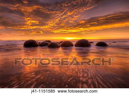 Moeraki boulders at dawn as SW front passes overhead, near Oamaru, Otago, View Large Photo Image Stock Photography - Moeraki boulders at dawn as SW front passes overhead, near Oamaru, Otago,. Fotosearch