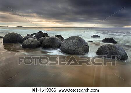 Moeraki boulders, sombre winter dawn, near Oamaru, Otago, South Island, New Zealand View Large Photo Image Stock Photograph - Moeraki boulders, sombre winter dawn, near Oamaru, Otago, South Island, New Zealand. Fotosearch