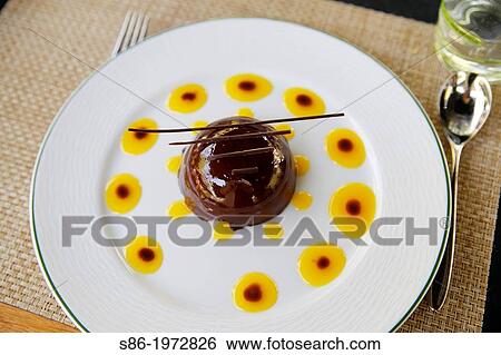 Molded Chocolate Bombe Dessert, Garnished With an Orange and Chocolate Glaze. View Large Photo Image Stock Photograph - Molded Chocolate Bombe Dessert, Garnished With an Orange and Chocolate Glaze.. Fotosearch