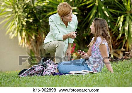 mom and daughter argue about cell phone use View Large Photo Image Stock Photo - mom and daughter argue about cell phone use. Fotosearch