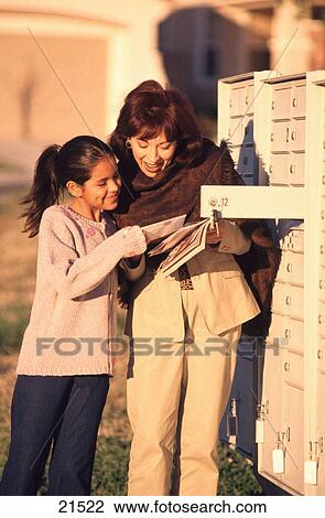 Stock Image - Mom and daughter at mail box. Fotosearch