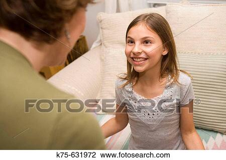 Stock Image - Mom and daughter having a talk. Fotosearch