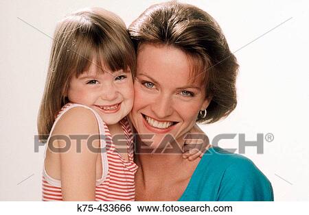 Mom and daughter hugging View Large Photo Image Stock Photograph - Mom and daughter hugging. Fotosearch