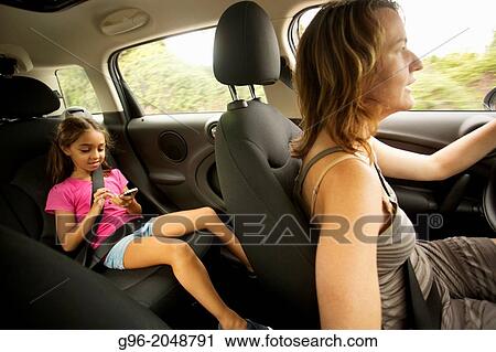 Mom and daughter into a car. View Large Photo Image Stock Image - Mom and daughter into a car.. Fotosearch