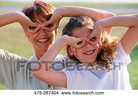 Picture - mom and daughter playing around together. Fotosearch