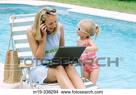 mom and daughter poolside with laptop View Large Photo Image Picture - mom and daughter poolside with laptop. Fotosearch