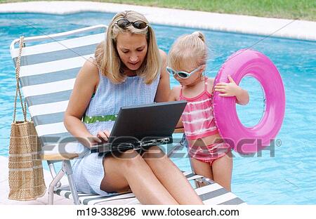 mom and daughter poolside with laptop View Large Photo Image Stock Photograph - mom and daughter poolside with laptop. Fotosearch
