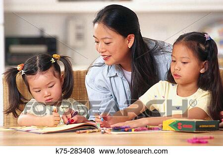 mom and her daughters drawing together View Large Photo Image Stock Photo - mom and her daughters drawing together. Fotosearch