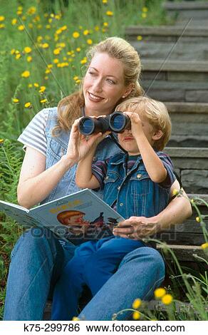 Stock Photograph - Mom and son using binoculars together. Fotosearch