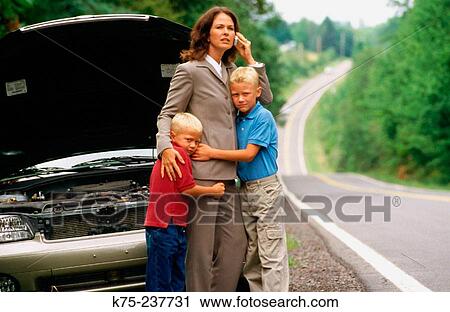 Mom broken down on a country road with her sons View Large Photo Image Stock Image - Mom broken down on a country road with her sons. Fotosearch