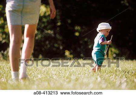 Mom chases after toddler in search of sticks. Pennsylvania. USA. View Large Photo Image Stock Image - Mom chases after toddler in search of sticks. Pennsylvania. USA.. Fotosearch