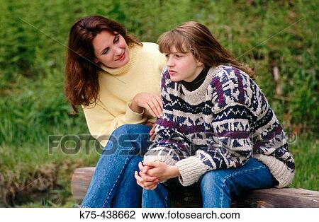 Stock Image - Mom comforting teen daughter. Fotosearch