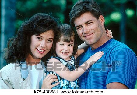 Stock Image - Mom, dad, and daughter portrait. Fotosearch