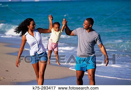 Mom, dad, and little daughter at the beach View Large Photo Image Stock Photo - Mom, dad, and little daughter at the beach. Fotosearch