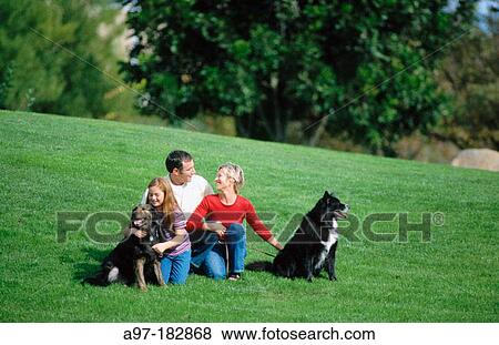 Mom, dad, daughter & dogs on hillside View Large Photo Image Stock Photo - Mom, dad, daughter & dogs on hillside. Fotosearch