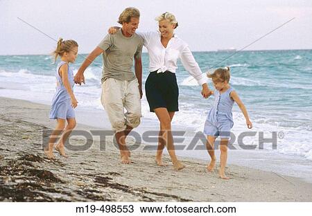 Mom & dad with twin girls at the beach View Large Photo Image Stock Image - Mom & dad with twin girls at the beach. Fotosearch
