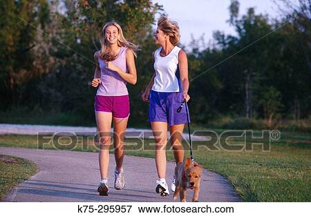 Mom, daughter jogging with their pet dog View Large Photo Image Stock Photo - Mom, daughter jogging with their pet dog. Fotosearch