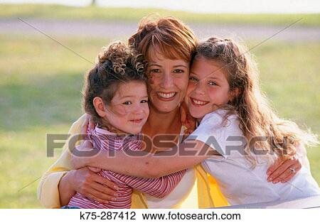 Mom gets big hugs from her daughters View Large Photo Image Stock Image - Mom gets big hugs from her daughters. Fotosearch
